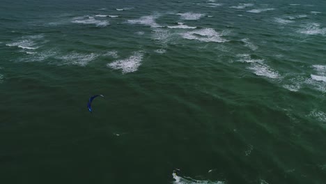 Aerial-Tracking-Shot-of-a-Male-Kite-Surfer-Off-the-Crystal-Coast-of-Emerald-Isle,-NC