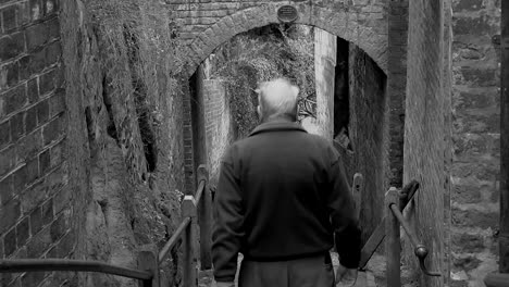 Old-man-walking-down-steps-in-Bridgnorth,-in-the-United-Kingdom-Both-Color-and-black-and-white-versions-from-5,-10,-15-seconds-to-long-version