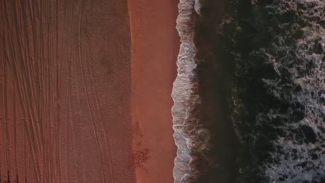 Extended-drone-flying-shot-of-beach-and-waves-at-sunset-in-Kauai,-Hawaii