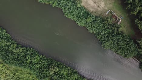 Drone-flying-up-and-away-from-river-in-Kauai,-Hawaii
