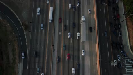 Reverse-tilting-aerial-shot-of-traffic-patterns-on-the-freeway-in-West-Los-Angeles-during-rush-hour