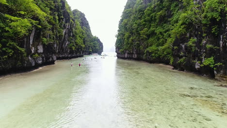 Dolly-In-Aerial-Shot-Of-Clear-Water-Passage-Between-Two-Mountains-In-Palawan-Philippines