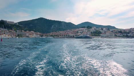 Trail-of-waves-behind-the-sailing-boat,-as-it-leave-the-coast-od-Hvar