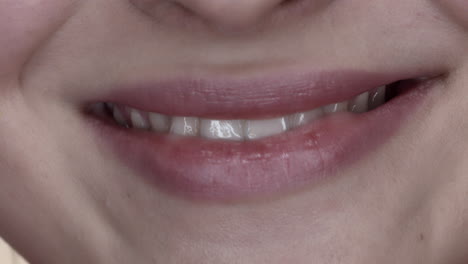 Macro-closeup-on-white-of-young-woman-smile
