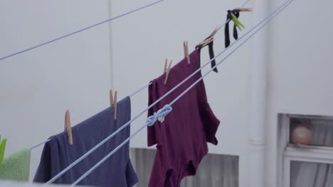 Steady-view-on-laundry-hanging-on-ropes-being-pulled-forward