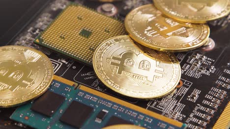 Bitcoins-on-circuit-board-and-processor,-turning-slowly-in-4k,-concept-cryptocurrency-mining-with-computer-components
