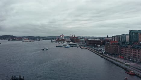 Aerial-Dolly-shot-of-Gothenburg-Port-near-river-during-cloudy-day