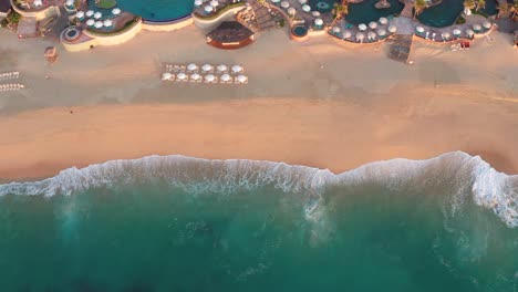 Amazing-seaside-beach-luxury-resort-swimming-pools,-aerial-birds-eye-view