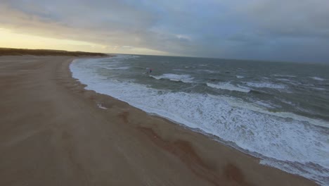 Drone-flying-towards-two-kitesurfers-during-a-dark-autumn-day-in-the-Netherlands