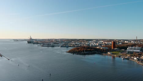 Drone-dolly-move-with-aerial-view-of-inlet-of-the-port-of-Gothenburg,-Sweden-during-late-afternoon