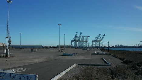 A-long-pan-up-to-view-the-cranes-across-the-shipping-lanes-on-a-sunny-day-in-the-bay