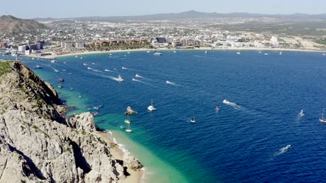 Yachts-moored-in-pacific-ocean-off-Cabo-San-Lucas-coast,-aerial-view-4K