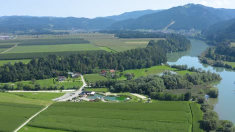 Aerial-View-Slovenia-countryside-with-Vodni-Park-center-and-Drava-River-to-the-right,-Drone-fly-out-reveal-shot