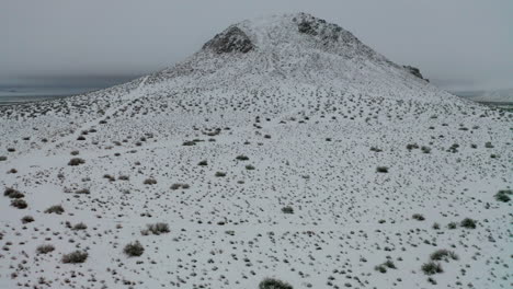Aerial-Pull-Back-Reveal,-White-Mountain-in-Mojave-Desert-Covered-in-Winter-Snow