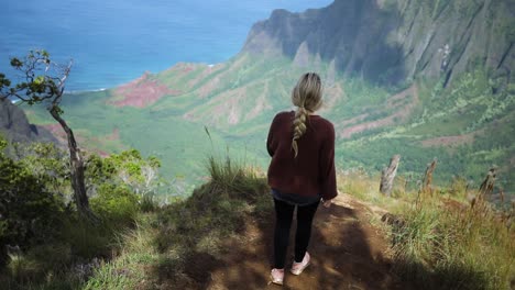 Young-Woman-Hiking-on-Trail-in-Napali-Coast-State-Park-in-Kauai,-Hawaii