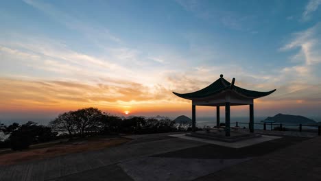 Sunset-over-pavilion-at-top-of-Clearwater-Bay-Peninsula,-Hong-Kong,-China