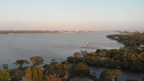 Aerial-View-of-South-Florida-Bayou-Leading-Out-into-River-With-Docks-Lining-The-Shore-During-Sunset