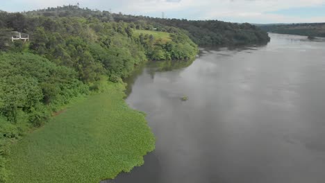 Aerial-shot-from-up-high-flying-over-the-river-Nile-with-the-lush-vegetation-growing-alongside-the-banks