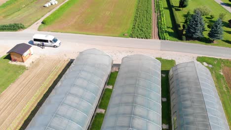 Low-aerial-flyover-of-greenhouses-with-vegetables-growing-in-them