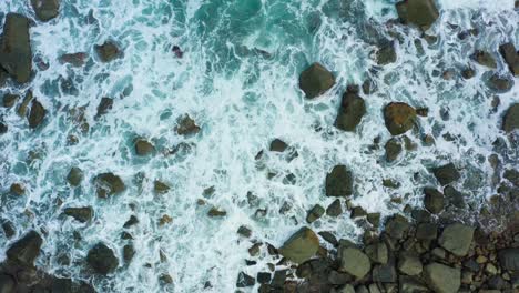 Aerial-view-of-waves-crashing-on-the-rock-beach