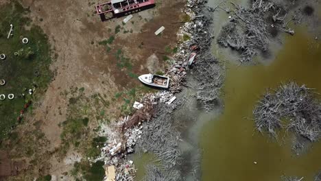 Birds-Eye-Aerial-View-of-Boat-Wreck-and-Waste-on-Shore-of-Puerto-Rico,-Aftermath-of-Hurricane-Natural-Disaster