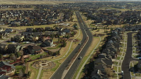 Panning-aerial-footage-of-South-Powhaton-road-and-the-Beacon-Point-neighborhood,-located-in-Southeast-Aurora,-Colorado