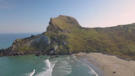 Aerial-dolly-out-of-Castle-Rock-and-beach-at-Castlepoint,-New-Zealand