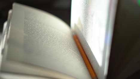 Pencil-holding-a-place-in-a-hardbound-book---close-up-center-focus-with-shallow-depth-of-field