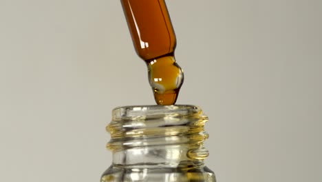 Classic-golden-oil-dropper-cannabis-cbd-thc-marijuana-medication-isolated