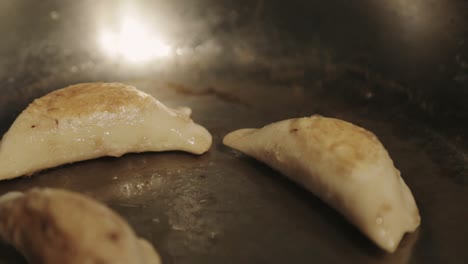 Frying-Dumplings-In-An-Oil-Heated-Skillet---Close-Up-Shot