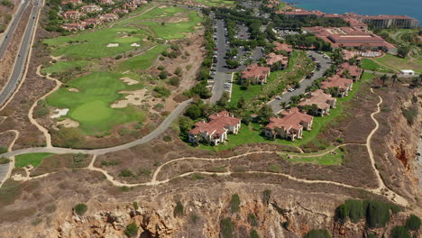 Panning-aerial-footage-of-the-Terranea-resort,-Terranea-Bluff-Top-Park,-and-The-Links-at-Terranea-in-Palos-Verdes,-Los-Angeles,-California