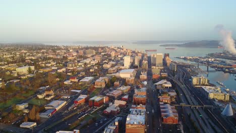 A-Stunning-Scenery-in-Tacoma,-Washington-With-Different-Buildings-and-Calm-Sea-During-Sunrise---Aerial-Shot