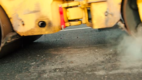 Compactor-is-driving-over-freshly-poured-asphalt-and-compresses-it-on-the-road-to-fix-a-hole