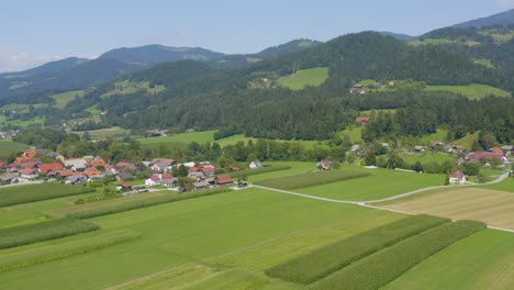 Aerial-view-of-Slovenj-Gradec-town-in-Slovenia-approaching-the-nearby-hills,-Drone-slow-dolly-in-approach