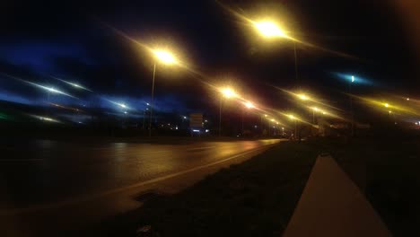 Night-traffic-light-speed-timelapse-headlight-beams-moving-along-dark-night-road