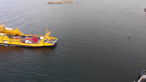 Drone-aerial-flight-approaching-loaded-car-ferry-in-Gothenburg's-northern-archipelago-in-Sweden