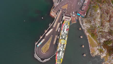Drone-aerial-top-down-view-of-docked-car-ferry-in-Gothenburg's-northern-archipelago-in-Sweden