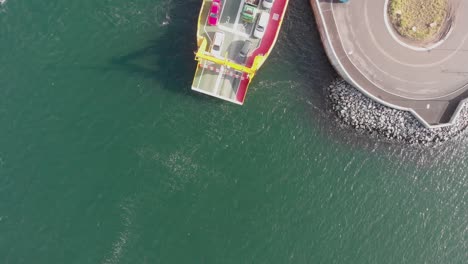 Aerial-bird's-eye-view-looking-down-at-car-ferry-docked-in-Gothenburg,-Sweden