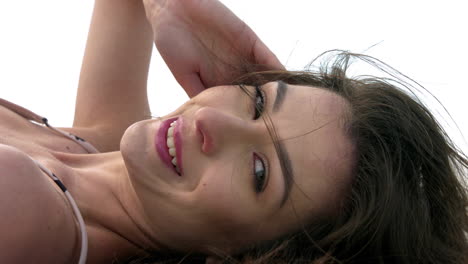 Close-up-of-female-model-face-with-brunette-hairs-posing-at-beach,slow-motion