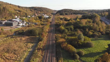 Aerial-Dolly-shot-of-railway-train-tracks-in-Gothenburg,-Sweden-during-sunny-day