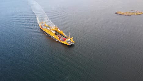 Backwards-aerial-drone-flight-with-view-of-car-ferry-in-northern-Gothenburg's-territory,-Sweden