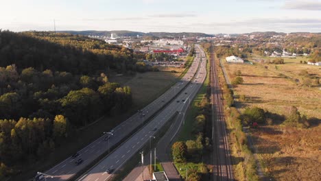 Aerial-Dolly-Shot-of-Cars-on-highway-speeding-during-beautiful-day-near-countryside-in-Gothenburg,-Sweden