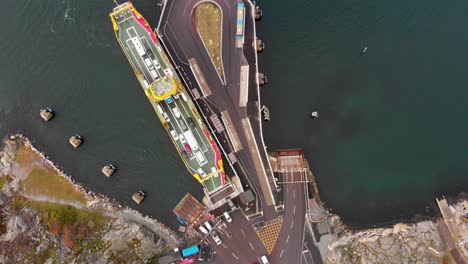 Cars-disembarking-the-docked-ferry-while-alongside-in-port-while-in-Gothenburg's-northern-archipelago,-Sweden