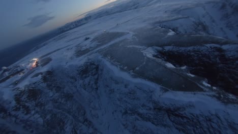 Aerial-view-of-the-most-northern-point-of-Europe-with-a-full-moon-during-winter,-the-Nordkapp
