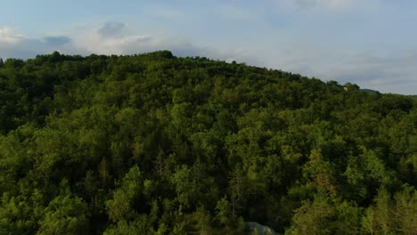 Forest-hill-near-lake-Butoniga-dam-in-Croatia-Istria-peninsula,-Aerial-drone-flyover-shot