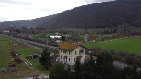 Cantoniera-residential-house-aerial-orbit-right-across-Frescobaldi-vineyard-Chianti-countryside-plantation