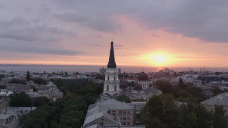 The-view-of-the-beautiful-yellow-sunrise-in-the-horizon-over-the-peaceful-city-of-Odessa,-Ukraine---Aerial-shot