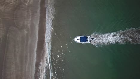 Aerial-bird-view,-of-an-amphibious-boat-travelling-back-from-the-sea-to-the-land,-4K