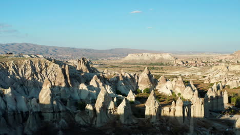 Flying-over-woman-driving-quad-towards-Love-Valley-in-Goreme,-Turkey