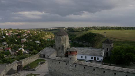 Flying-over-the-beautiful-Kamianets-Podilskyi-castle-by-an-old-well-preserved-town-in-Ukraine---Aerial-shot
